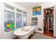 Bright bathroom featuring a clawfoot tub, artistic touches, and plenty of natural light at 1069 Colquitt Ne Ave, Atlanta, GA 30307