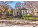 Charming bungalow-style home with inviting front porch and mature trees, framed by a decorative wrought iron fence at 1069 Colquitt Ne Ave, Atlanta, GA 30307