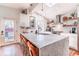 Sunlit kitchen features a long island with marble countertop, barstool seating, and pendant lighting at 1069 Colquitt Ne Ave, Atlanta, GA 30307