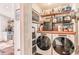 Efficient laundry room equipped with modern washer/dryer units, shelving, and ample storage at 1069 Colquitt Ne Ave, Atlanta, GA 30307