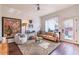 Bright living room showcasing hardwood floors, decorative rug, neutral tones, and abundant natural light from the exterior at 1069 Colquitt Ne Ave, Atlanta, GA 30307