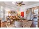 Elegant living room with high ceilings, a ceiling fan, a staircase, and natural light from large windows at 1069 Colquitt Ne Ave, Atlanta, GA 30307