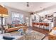 Open-concept living room flows into the kitchen, featuring a leather sofa, modern decor, and natural light at 1069 Colquitt Ne Ave, Atlanta, GA 30307