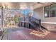 Spacious brick patio featuring a covered area with stylish decking and stairs to a backyard space at 1069 Colquitt Ne Ave, Atlanta, GA 30307