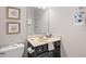 Stylish bathroom with black vanity, framed mirror, and nautical decor at 345 Crown Vetch Ln, Alpharetta, GA 30005