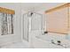 Bathroom with large tub, glass-enclosed shower, and neutral tones at 345 Crown Vetch Ln, Alpharetta, GA 30005