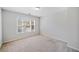 Bright bedroom with plush carpet, neutral walls, and large window at 345 Crown Vetch Ln, Alpharetta, GA 30005