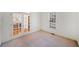 Bright and airy bedroom with neutral carpet, white walls, and french doors leading to dining room at 345 Crown Vetch Ln, Alpharetta, GA 30005