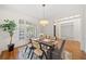 Bright dining room with wood floors, natural light, a table with seating for six, and elegant decor at 345 Crown Vetch Ln, Alpharetta, GA 30005