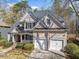 Attractive two-story home boasting a two-car garage, neutral siding, and well-maintained landscaping at 345 Crown Vetch Ln, Alpharetta, GA 30005