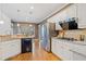 Modern kitchen with white cabinets, stainless steel appliances, granite countertops, and hardwood floors at 345 Crown Vetch Ln, Alpharetta, GA 30005