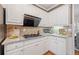 Cozy kitchen features white cabinetry, granite countertops and stainless steel vent hood at 345 Crown Vetch Ln, Alpharetta, GA 30005