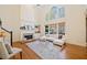 Spacious living room features fireplace, large windows, and soaring ceilings at 345 Crown Vetch Ln, Alpharetta, GA 30005
