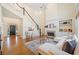 Bright living room with fireplace, built-ins, and staircase access at 345 Crown Vetch Ln, Alpharetta, GA 30005