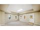 Bright living room featuring neutral walls and carpet and ample natural light from multiple windows at 345 Crown Vetch Ln, Alpharetta, GA 30005
