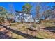 Fenced backyard features mature trees and shrubbery, with a gray two-story house at 4663 Hairston Crossing Pl, Stone Mountain, GA 30083