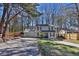 Inviting two-story home boasts a spacious driveway and attached two-car garage, surrounded by mature trees at 4663 Hairston Crossing Pl, Stone Mountain, GA 30083