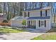 Traditional two-story home with an attached garage, complemented by a green lawn and well-manicured landscaping at 4663 Hairston Crossing Pl, Stone Mountain, GA 30083