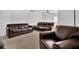 Spacious living room featuring plush leather furniture and neutral carpeting, perfect for relaxation at 4663 Hairston Crossing Pl, Stone Mountain, GA 30083