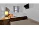Comfortable bedroom featuring carpet, a bed, a nightstand with a lamp, and a TV on the wall at 4663 Hairston Crossing Pl, Stone Mountain, GA 30083