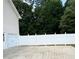 Backyard with white fence and garage, offering privacy and security at 112 Village Ct, Woodstock, GA 30188
