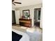Relaxing bedroom featuring a stylish dresser, wood floors, and modern artwork at 112 Village Ct, Woodstock, GA 30188