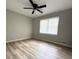 Bedroom with hardwood floors and a large window with plenty of natural light and neutral walls at 112 Village Ct, Woodstock, GA 30188