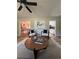Bright living room with modern decor, a round coffee table, and an open view to the kitchen at 112 Village Ct, Woodstock, GA 30188