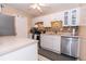 Bright kitchen with white cabinetry, stainless steel appliances, and a mosaic backsplash at 1325 Branch Dr, Tucker, GA 30084