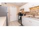 Updated kitchen featuring white cabinets, modern appliances, and stylish backsplash at 1325 Branch Dr, Tucker, GA 30084