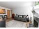 Comfortable living room with a fireplace, plush sofa, and view into the kitchen at 1325 Branch Dr, Tucker, GA 30084
