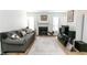 Well-lit living room featuring a fireplace, a comfortable couch, and a neutral-toned rug at 1325 Branch Dr, Tucker, GA 30084