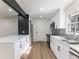 Well-lit kitchen boasting stainless steel appliances, white cabinets, and a stylish gray backsplash at 1783 Big Valley Ln, Stone Mountain, GA 30083