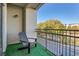 Relaxing balcony view featuring a chair overlooking a serene street and lush trees at 390 17Th Nw St # 4031, Atlanta, GA 30363