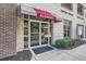 Welcoming building entrance with glass doors, awning, and clear signage at 390 17Th Nw St # 4031, Atlanta, GA 30363