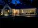 A nighttime view of the house showcases an elegant exterior, accented with a decorative fence and outdoor lighting at 584 Cherokee Ne St, Marietta, GA 30060