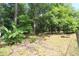 A spacious backyard offers a lush landscape with mature trees, and gardening beds at 584 Cherokee Ne St, Marietta, GA 30060
