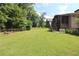 View of the fenced backyard with patio and lush grass at 584 Cherokee Ne St, Marietta, GA 30060