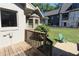 Exterior view of the backyard with a wooden deck and green lawn area, and a green chair at 584 Cherokee Ne St, Marietta, GA 30060