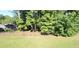 A fenced backyard features mature trees and small garden beds, enhancing the outdoor appeal at 584 Cherokee Ne St, Marietta, GA 30060
