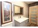 Modern bathroom with brick accent wall, floating vanity, mirror, and stylish wood door at 584 Cherokee Ne St, Marietta, GA 30060