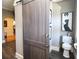 Stylish bathroom featuring a sliding barn door and a modern toilet at 584 Cherokee Ne St, Marietta, GA 30060