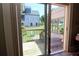 View of the exterior patio from inside through sliding glass doors to wood deck at 584 Cherokee Ne St, Marietta, GA 30060