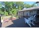 A wooden deck featuring modern cable railings, with multiple chairs that create a relaxing outdoor seating area at 584 Cherokee Ne St, Marietta, GA 30060