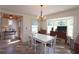 Open-concept dining room featuring wood floors, natural light, and a modern chandelier at 584 Cherokee Ne St, Marietta, GA 30060