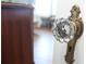 Close-up of a vintage doorknob on a white door with a glimpse of the home's interior at 584 Cherokee Ne St, Marietta, GA 30060