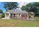 A charming home with a well-manicured lawn, dark fence, and patio seating provides curb appeal at 584 Cherokee Ne St, Marietta, GA 30060