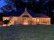 Inviting home exterior at night, showcasing a cozy bay window and warm lighting highlighting the facade at 584 Cherokee Ne St, Marietta, GA 30060