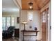 Foyer with hardwood floors, a wooden door, a table with lamp, and transom window at 584 Cherokee Ne St, Marietta, GA 30060