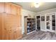 Hallway featuring wooden cabinets, glass doored display cabinet and wood floors at 584 Cherokee Ne St, Marietta, GA 30060
